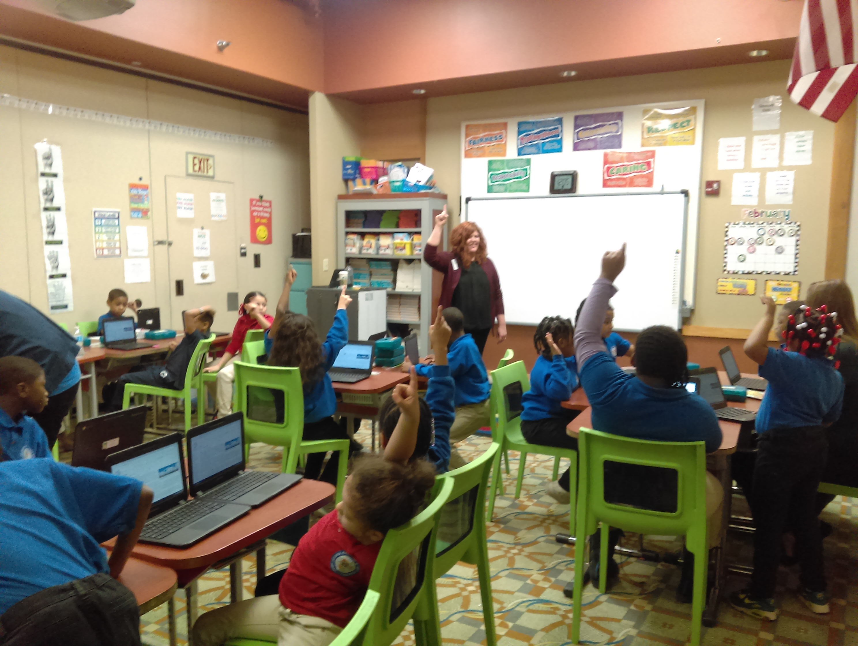 Rachel Herron leading a group of elementary students in a classroom