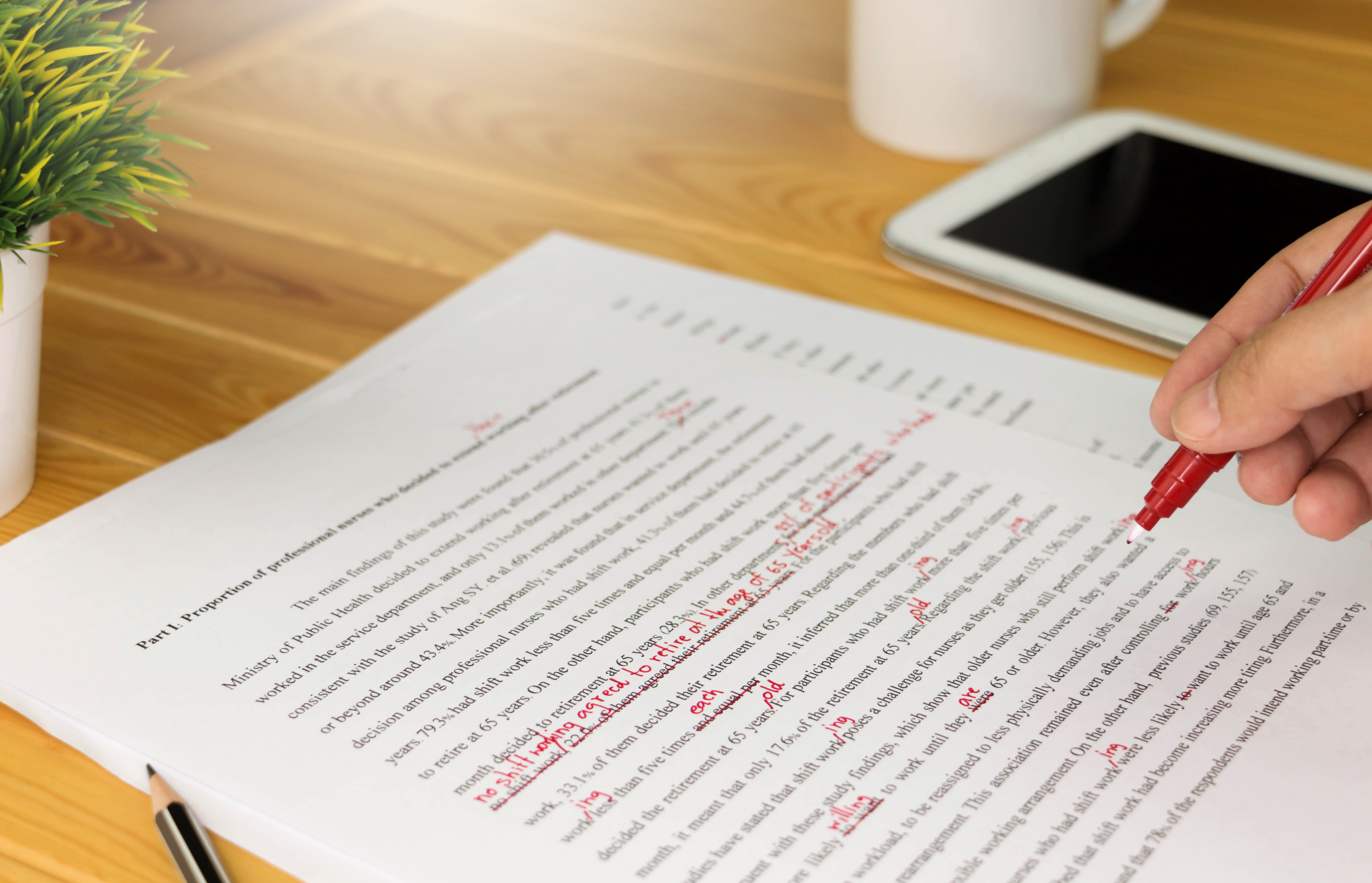 red pen markups on a typed paper