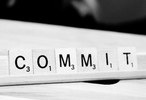 Scrabble letter tiles in spell the word commit