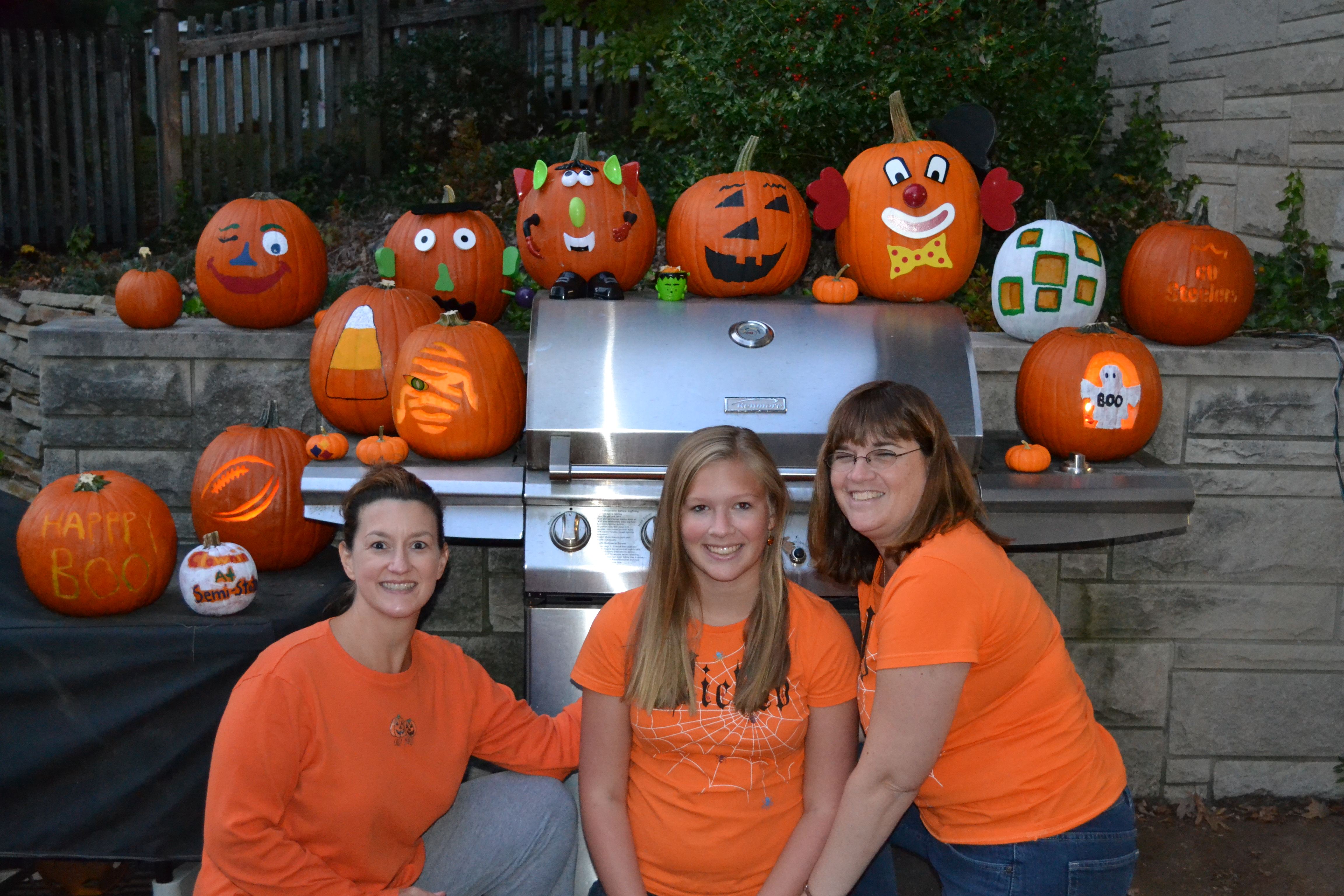 Sandy, her daughter Courtney, her friend Donna and painted pumkins