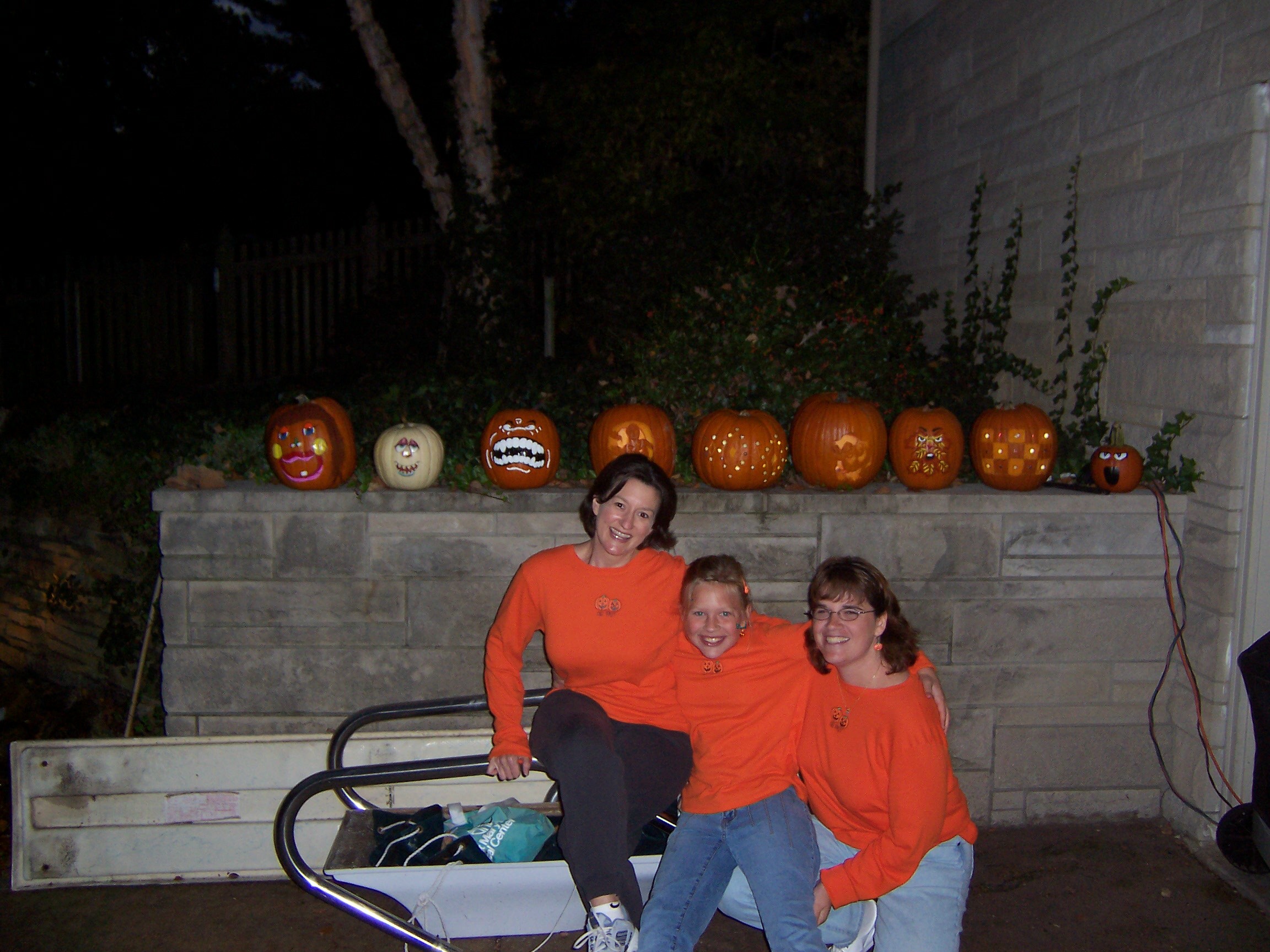 Sandy, her daughter Courtney, and her friend Donna with painted pumkins