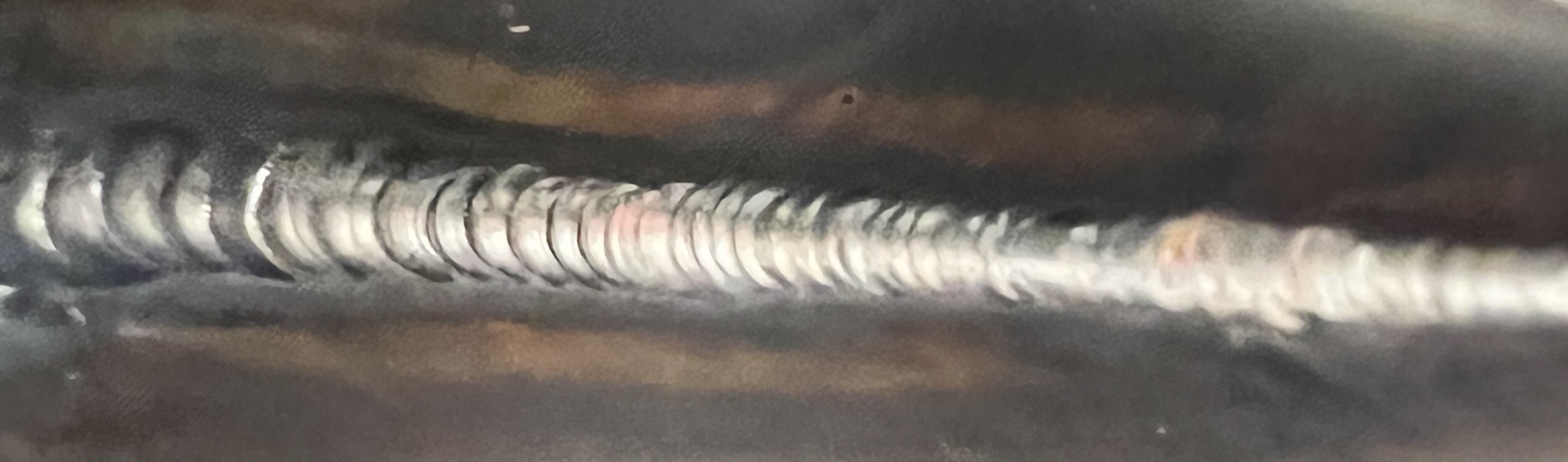 image of a TIG weld on steel that looks like stacked dimes
