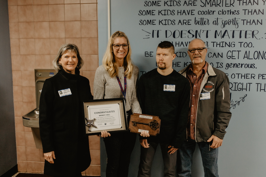 Starfish award winner, Mandy Hall, with a student and parents