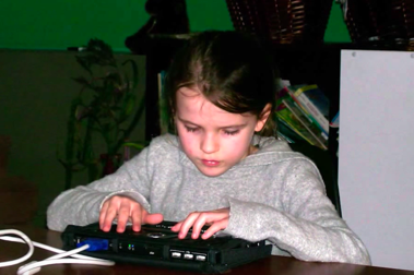 female student using braille reader