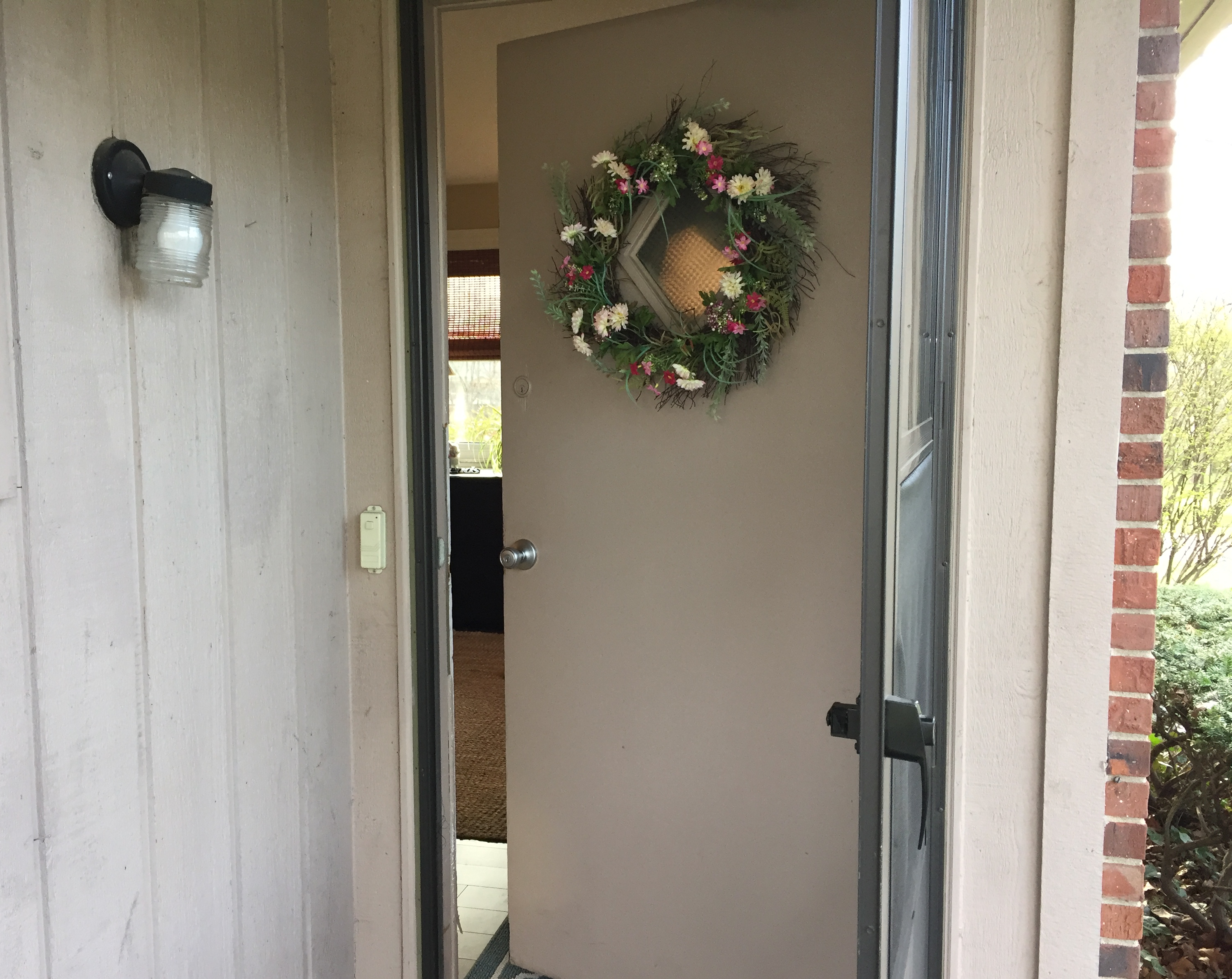 front porch view of door slightly open