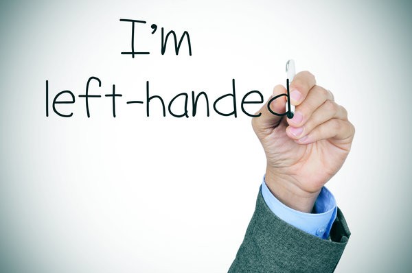 Left arm lifted holding a pencil