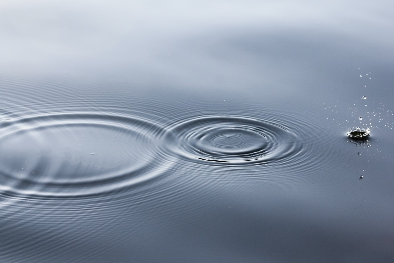 picture of water with ripples from a skipping stone