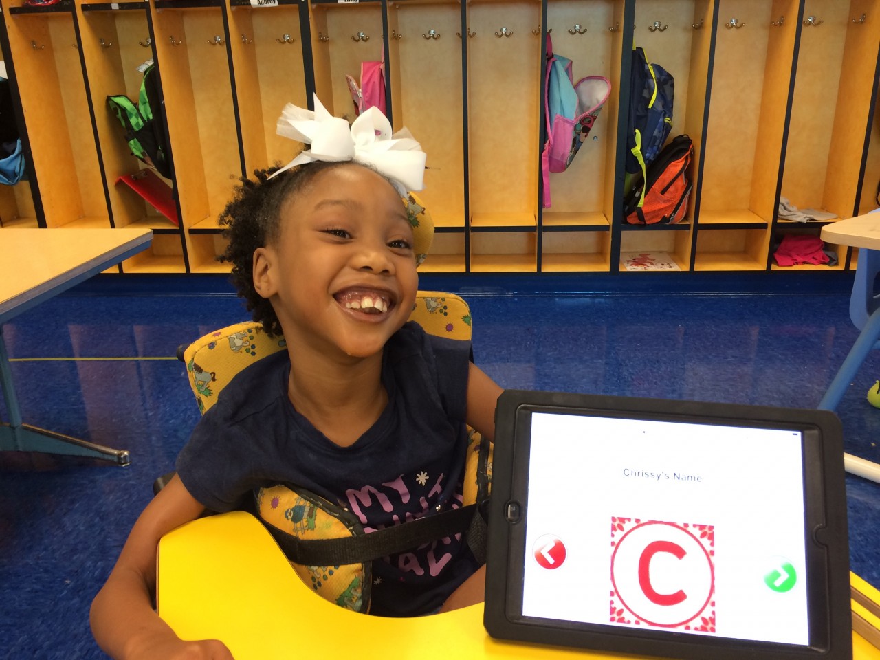 IMG_071_Smiling girl showing her book on her iPad written for her