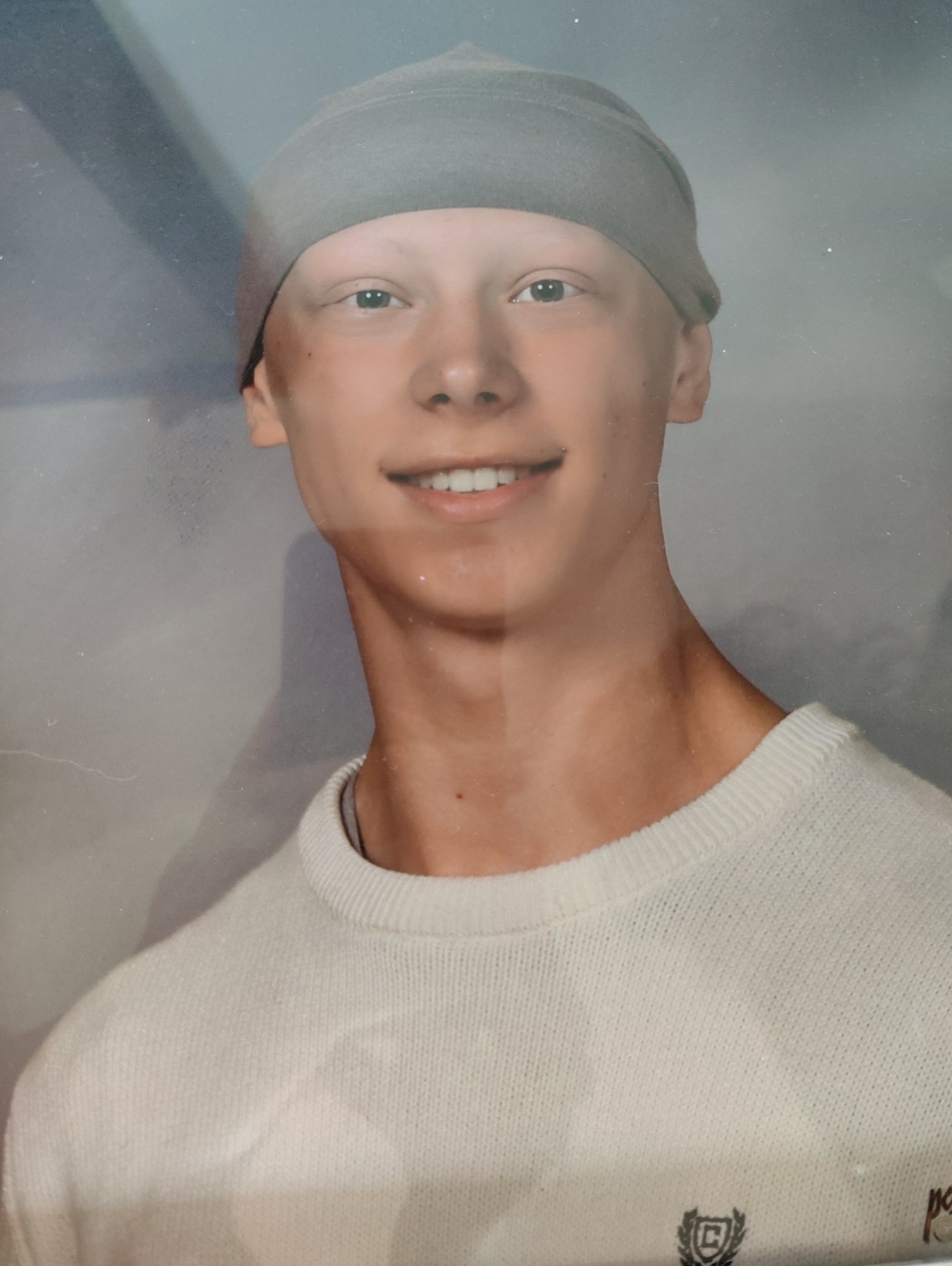 High School photo of Jack with white sweater and gray hat