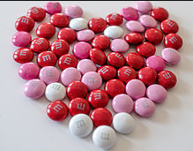 Pink & read M&M candies in heart shape.