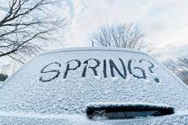 rear car window covered in snow with the word 
